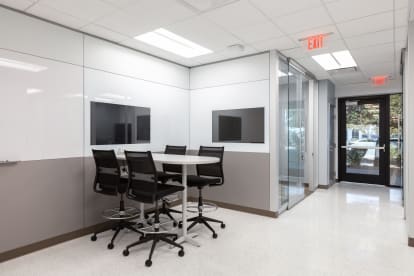 This open meeting space is bordered by DIRTT's solid modular walls featuring integrated technology and writeable surfaces.