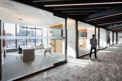 Image of two private offices with a large modular glass wall installation, letting the light in.