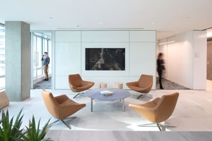 Image of a office lounge area built with prefab modular solid walls panels and integrated technology in the wall