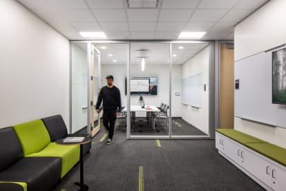 College student centre meeting room with prefab glass swing doors and mounted technology