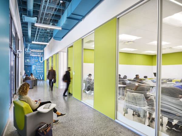Hallway of modern university with modular glass walls and wall graphics