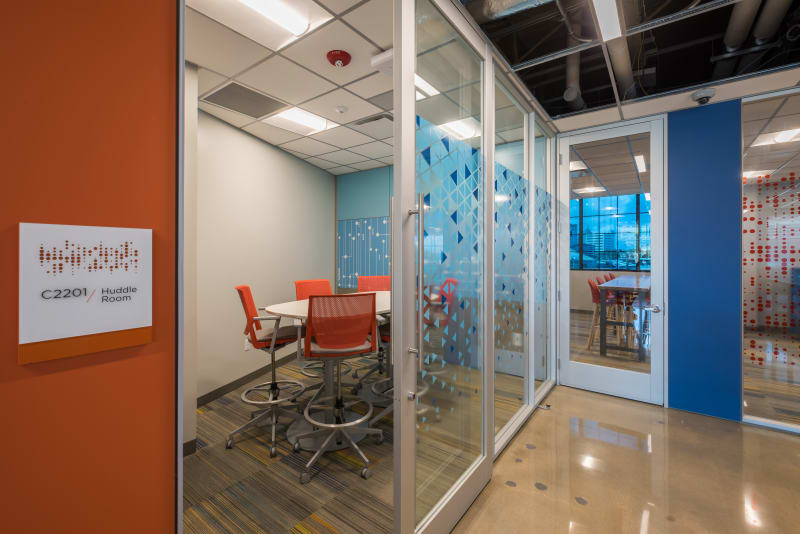 School meeting room with modular glass walls, custom graphics, and sliding doors
