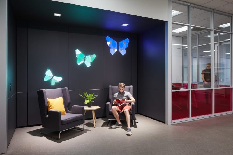This recessed waiting area features DIRTT's solid modular walls with integrated custom light graphics.