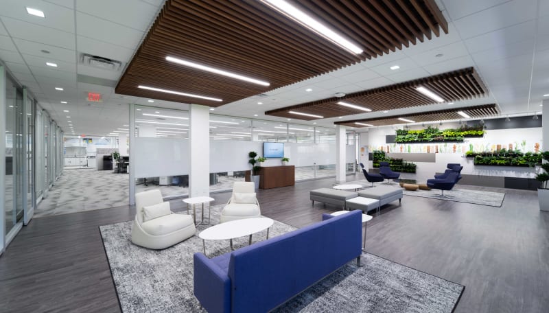 The waiting area is separated from the open work area with a combination solid and glass modular wall.