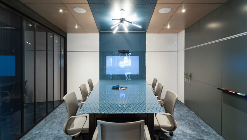 DIRTT's solid and glass modular walls form this meeting room with an integrated display and writeable surfaces.