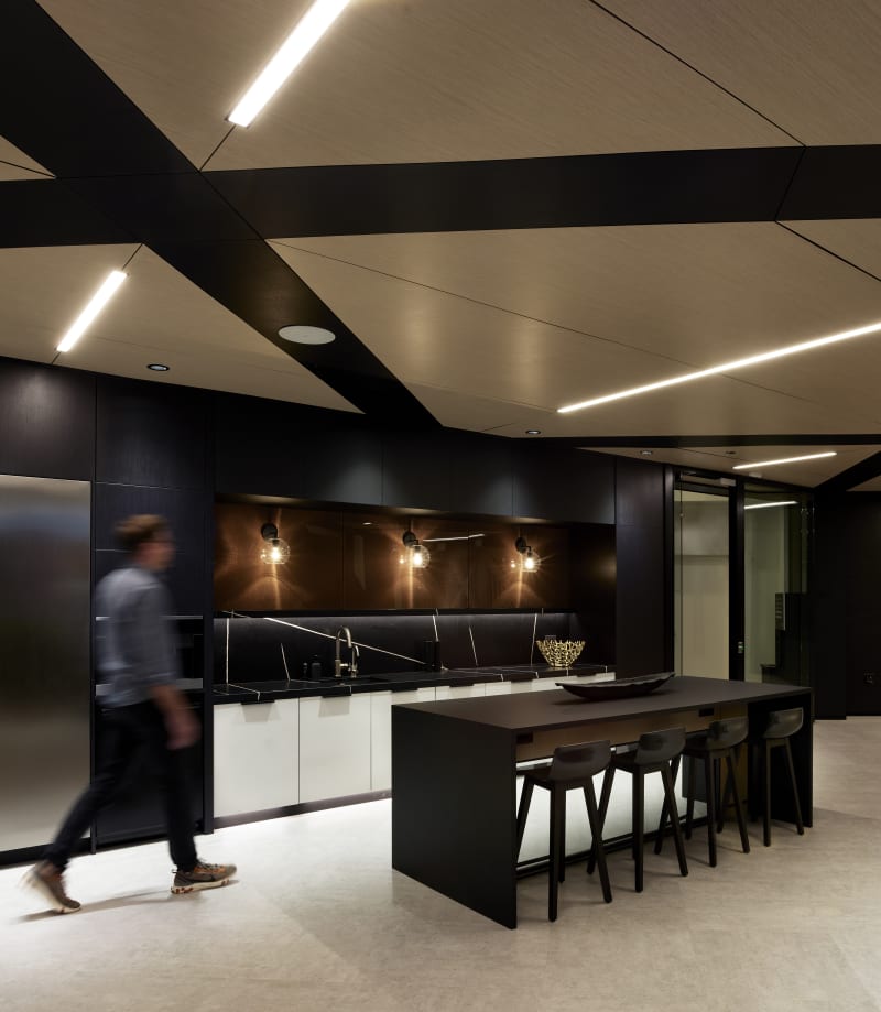 This open kitchen area is backed by a solid DIRTT wall featuring custom graphics and custom casework cabinets.