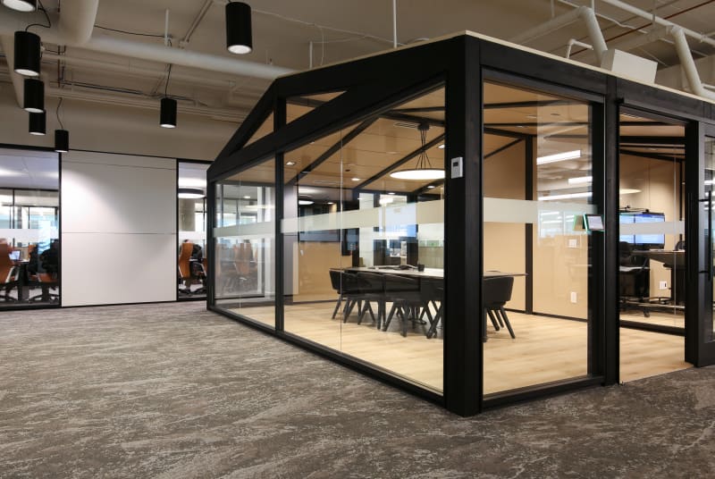 DIRTT's TImber Frame and modular glass and solid walls create free standing offices and meeting spaces.