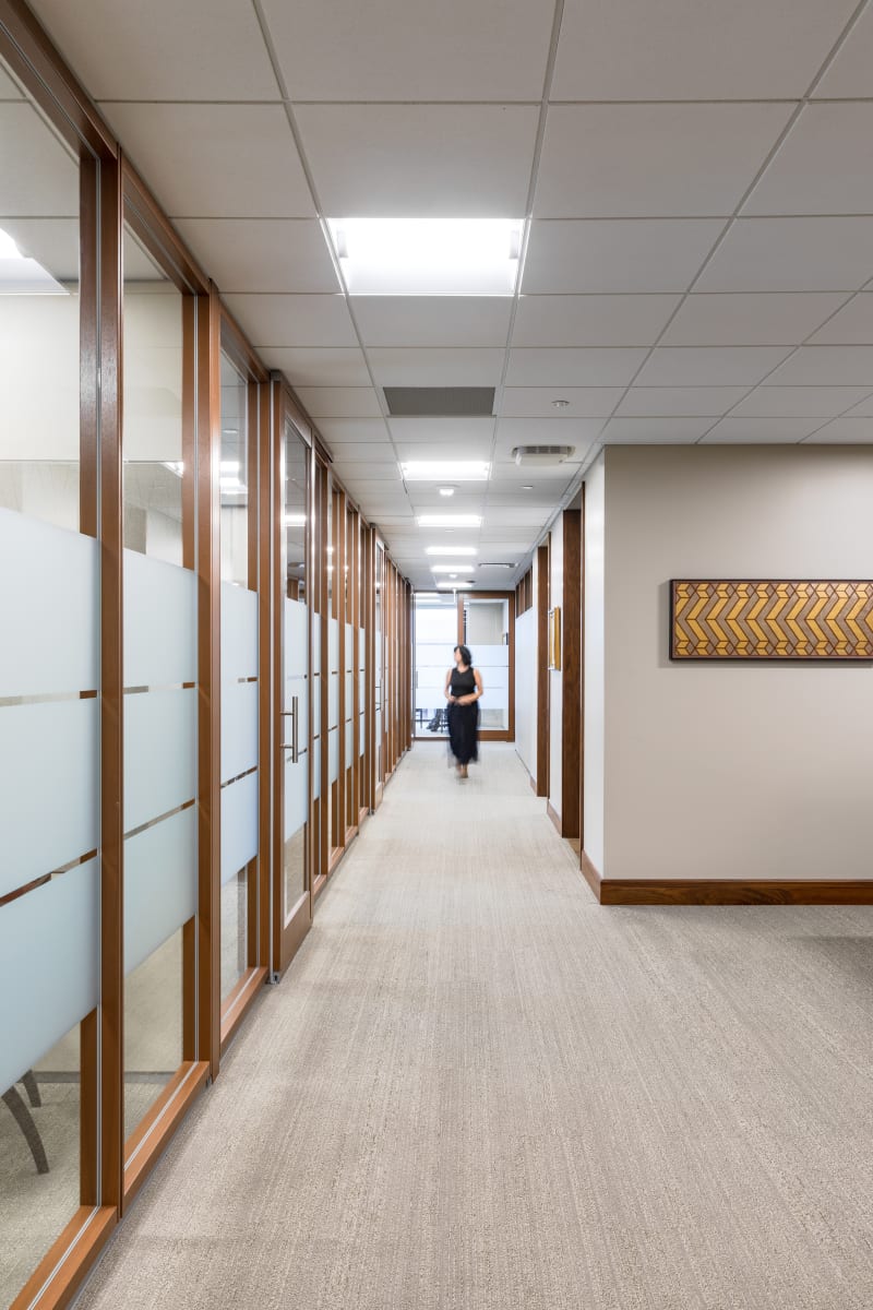 On the left side of this hallway are DIRTT's modular glass wall that have been used to create private offices.