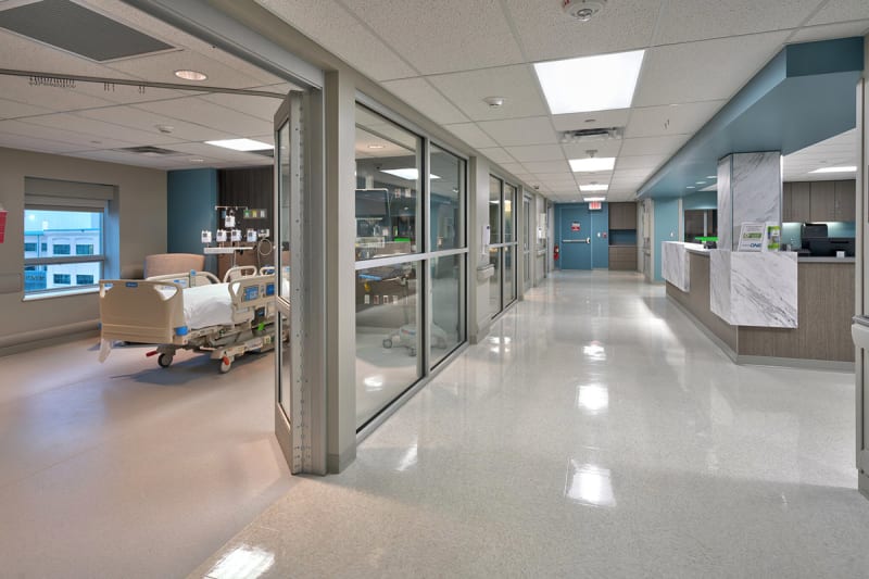 At the far end of this patient care room A DIRTT headwall with med gas and integrated power is visible.