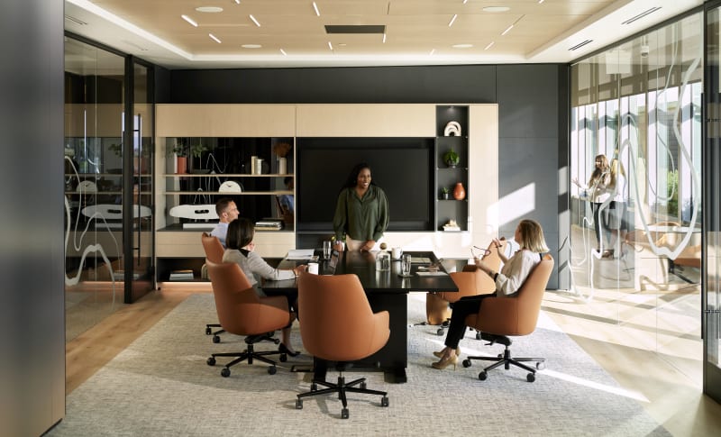 This meeting room has Reflect glass and solid DIRTT modular walls with custom casework cabinets and integrated technology.