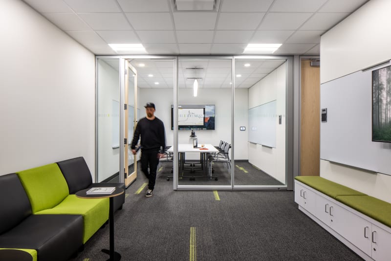College student centre meeting room with prefab glass swing doors and mounted technology