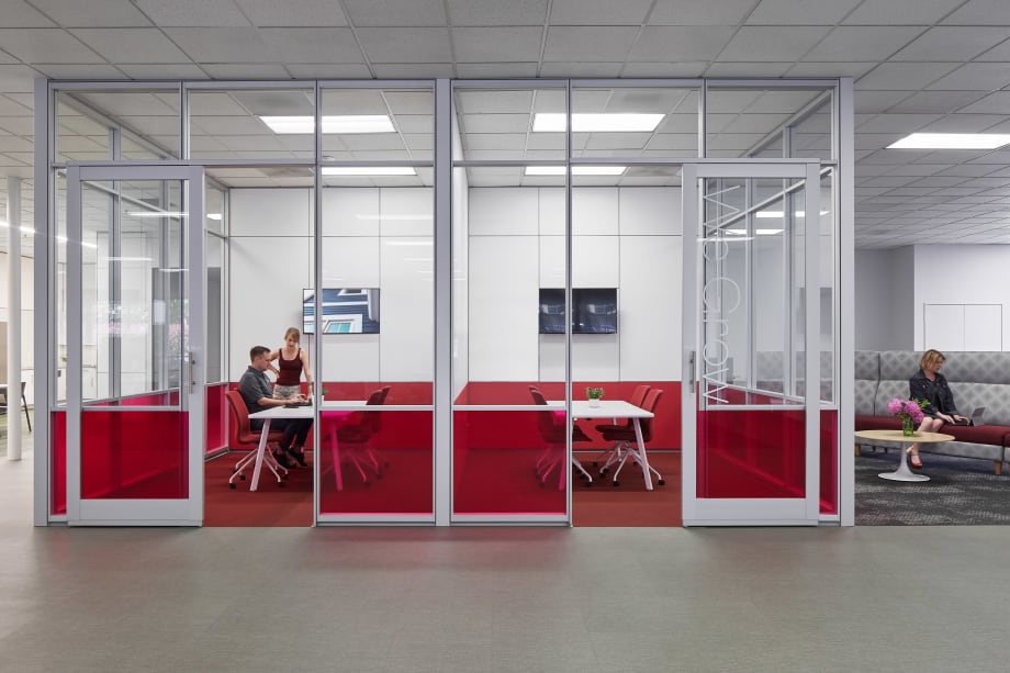 Enclosed by DIRTT's glass walls with custom graphics and solid modular walls, this freestanding pod has two meeting areas.