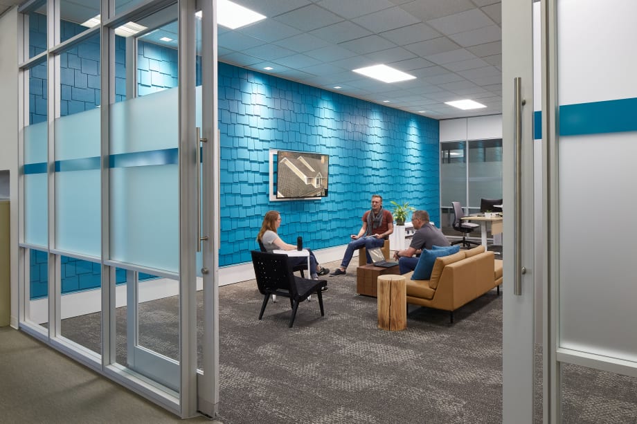 The entrance to this meeting space is via an aluminum framed sliding glass door within a glass wall system.