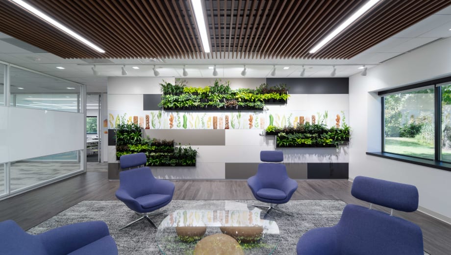 This waiting area feature wall is a DIRTT solid modular wall with custom graphics and integrated Breathe living plant wall.
