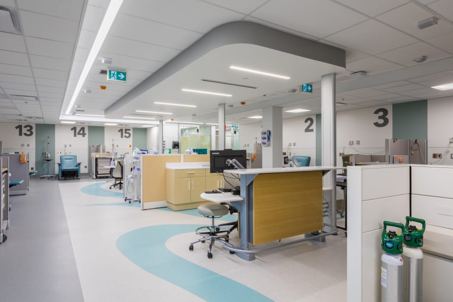 This open hospital area has various exam spaces with DIRTT headwalls and nurse stations.
