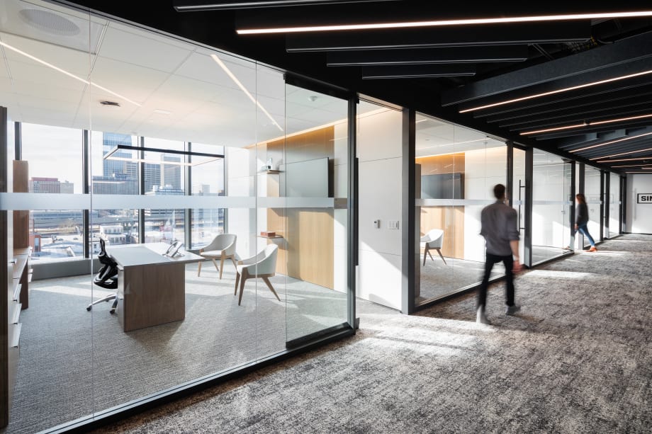 This hallway shot shows how DIRTT's modular glass wall system and solid walls create private offices.