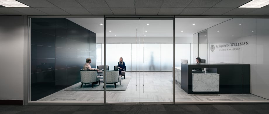 Pivoting interior glass doors leading into a corporate office