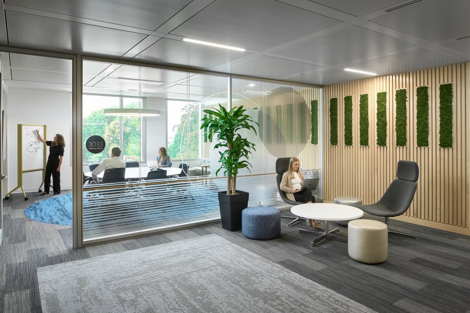 Image of an office space and meeting room built using a modular double pane glass wall system