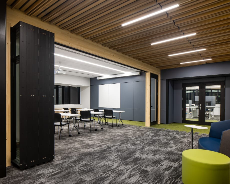Modern campus conference room with foldable glass doors under time ceiling