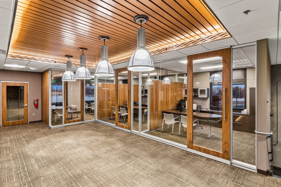 Private offices have been created with a combination of solid and glass modular walls. with sliding glass doors.