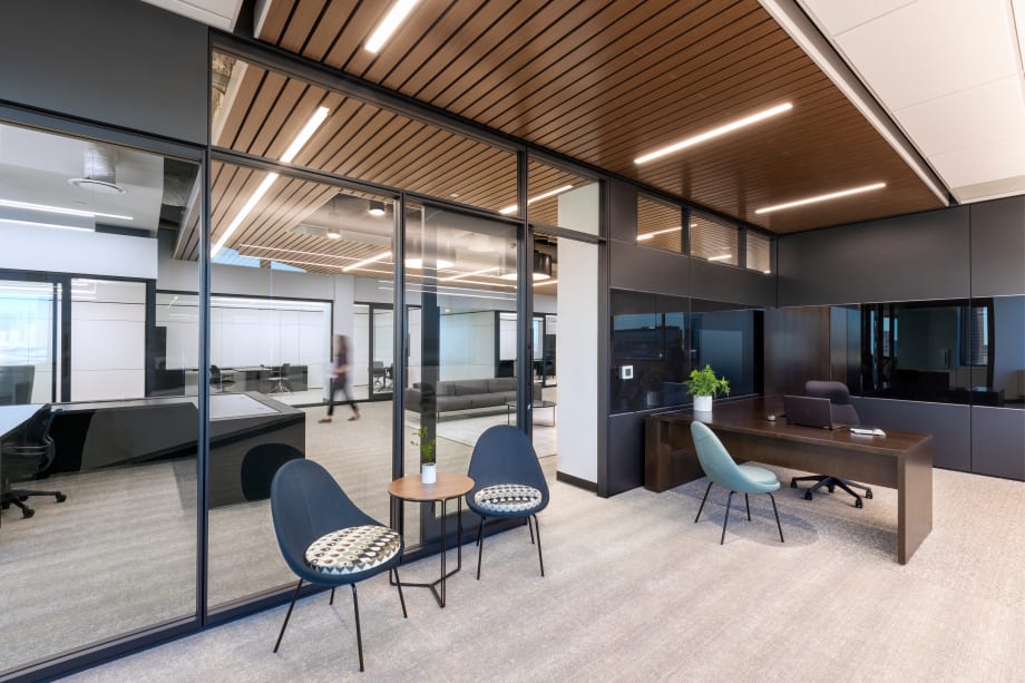 Inside this office we see DIRTT's solid, glass and combination walls with aluminum framed glass sliding door.