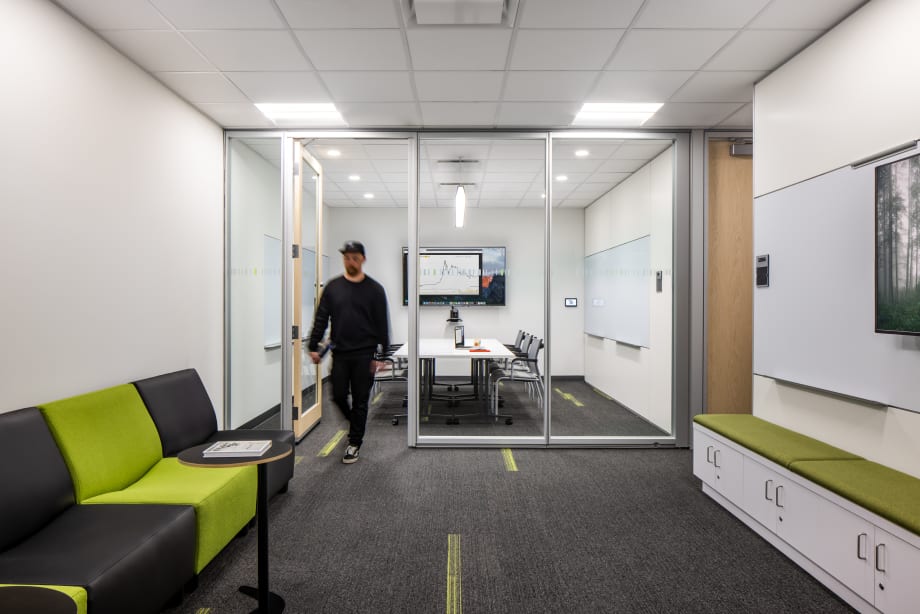 College student centre meeting room with prefab glass swing doors and mounted technology