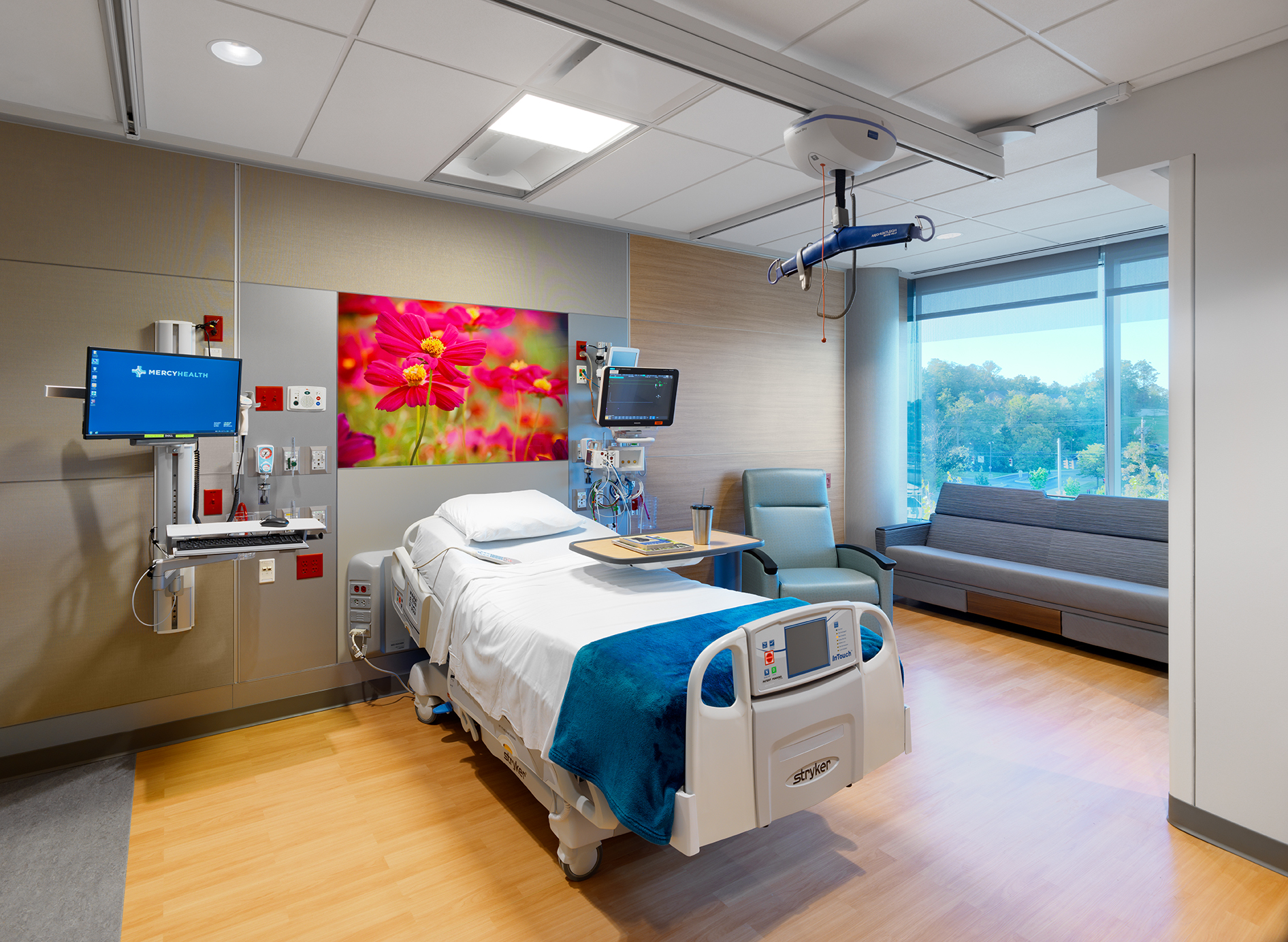 This exam room features DIRTT's headwall system with custom graphics and integrated med gasses, and modular walls.