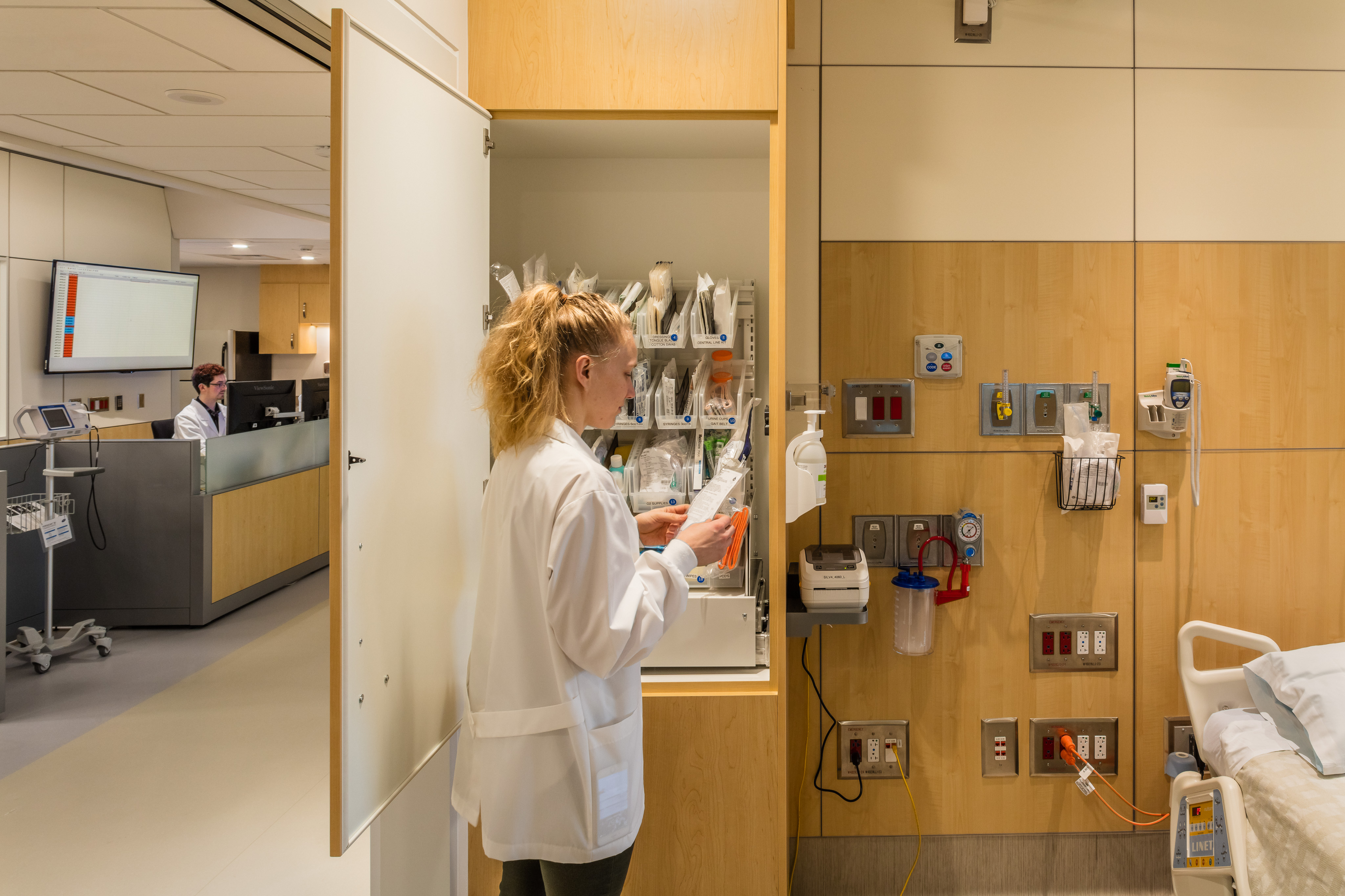 Custom casework cabinets store supplies in this hospital patient room.