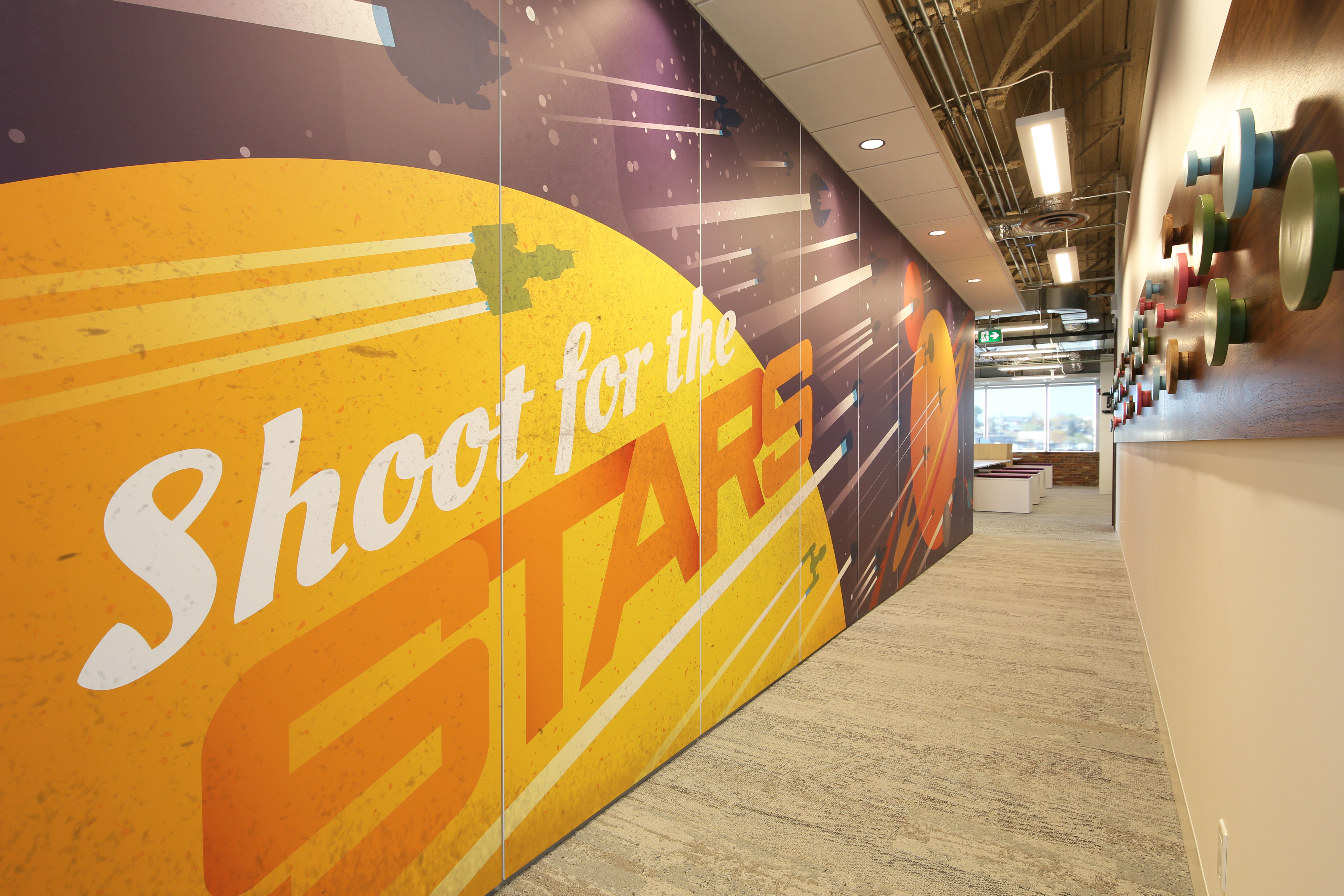 This hallway is lined with a sold modular DIRTT wall that features custom graphics.