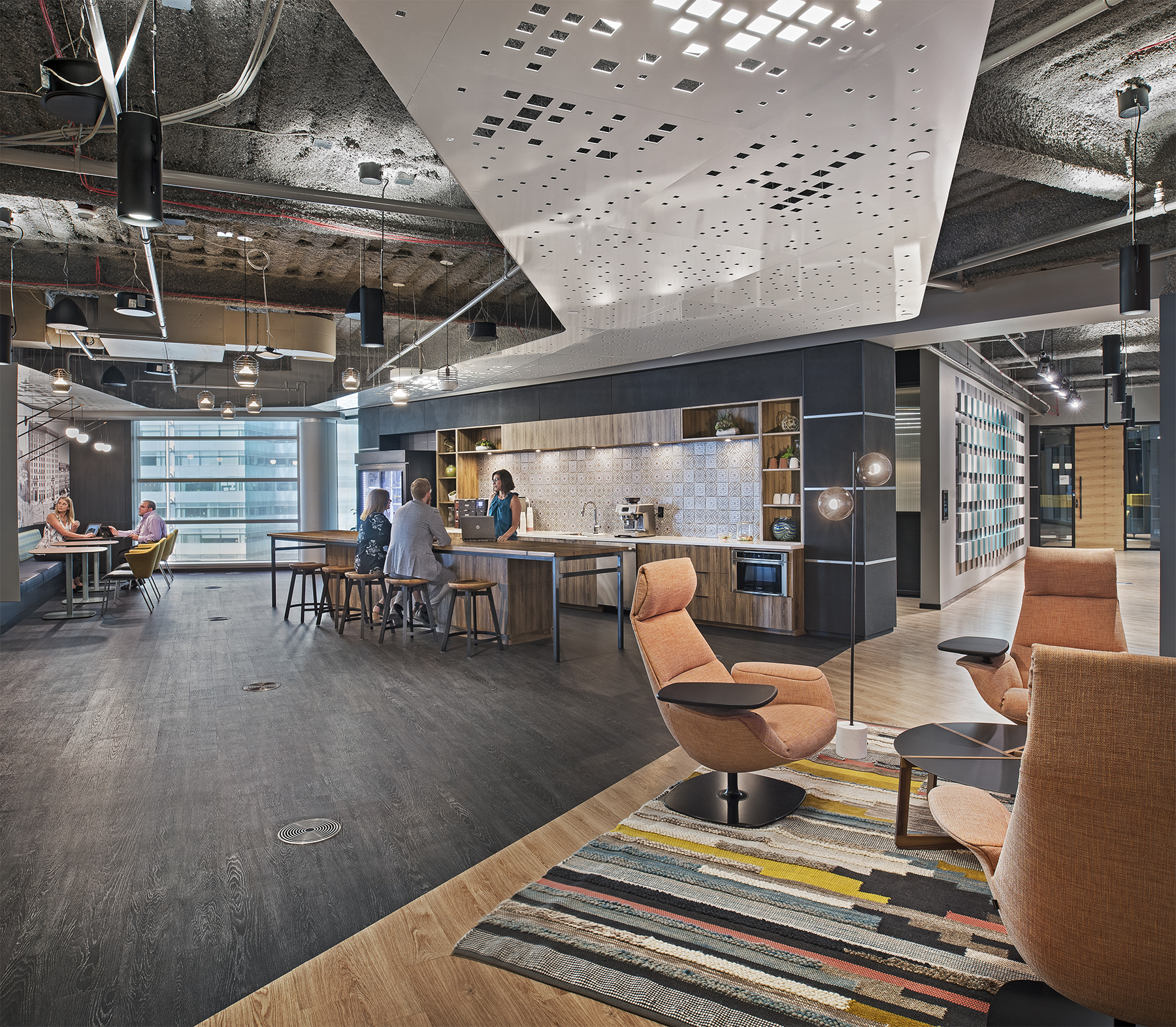 An open space with a coffee station/java center featuring custom casework and DIRTT's solid modular walls.