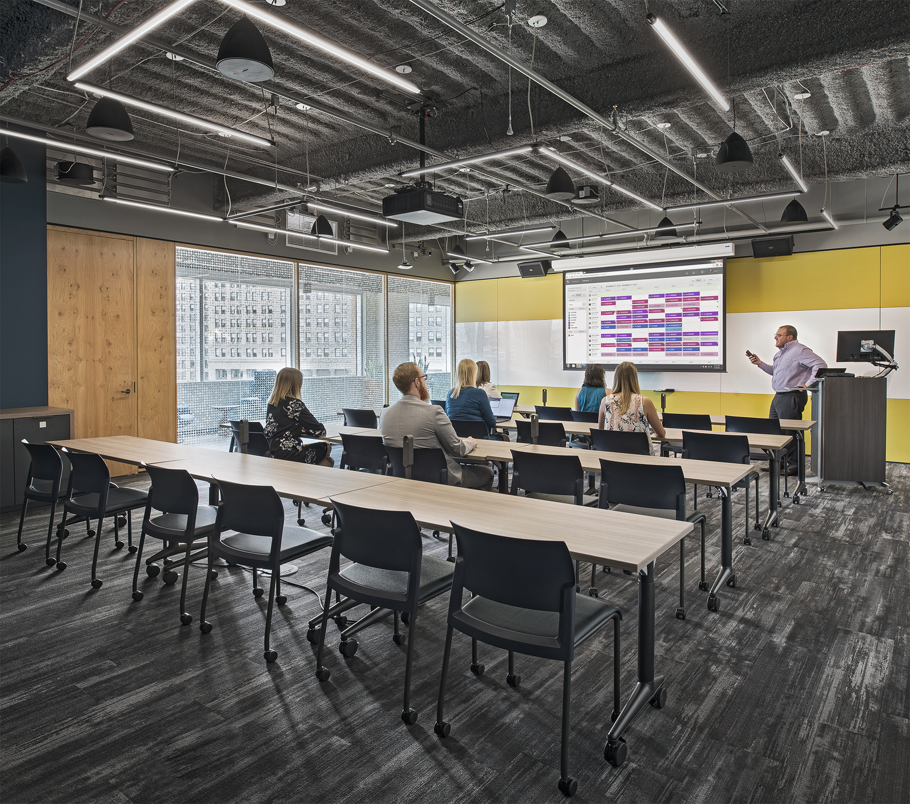 This classroom area features DIRTT's modular solid and glass walls along with writeable surfaces.
