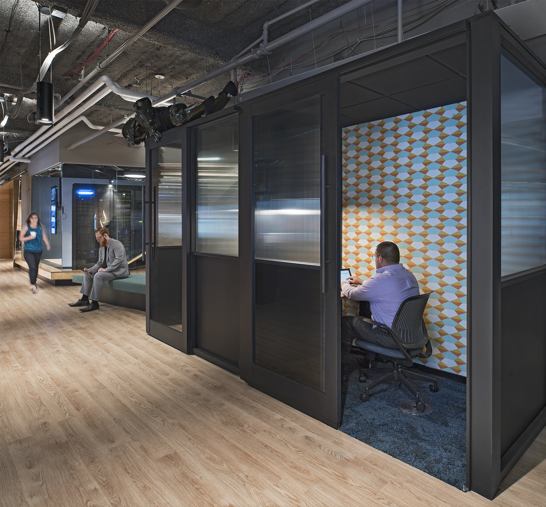 This freestanding modular office pod constructed by DIRTT has a sliding glass door.
