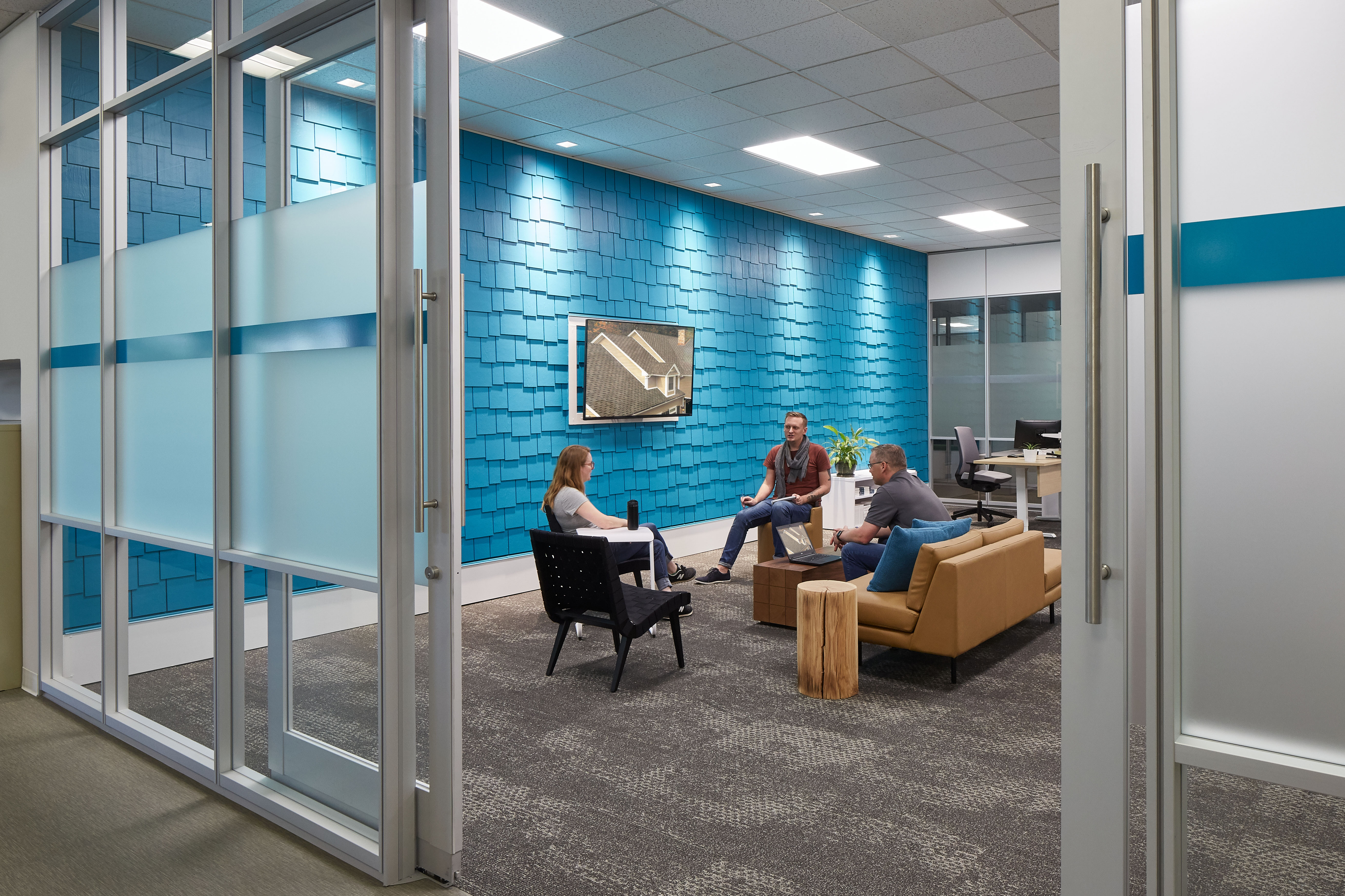 The entrance to this meeting space is via an aluminum framed sliding glass door within a glass wall system.