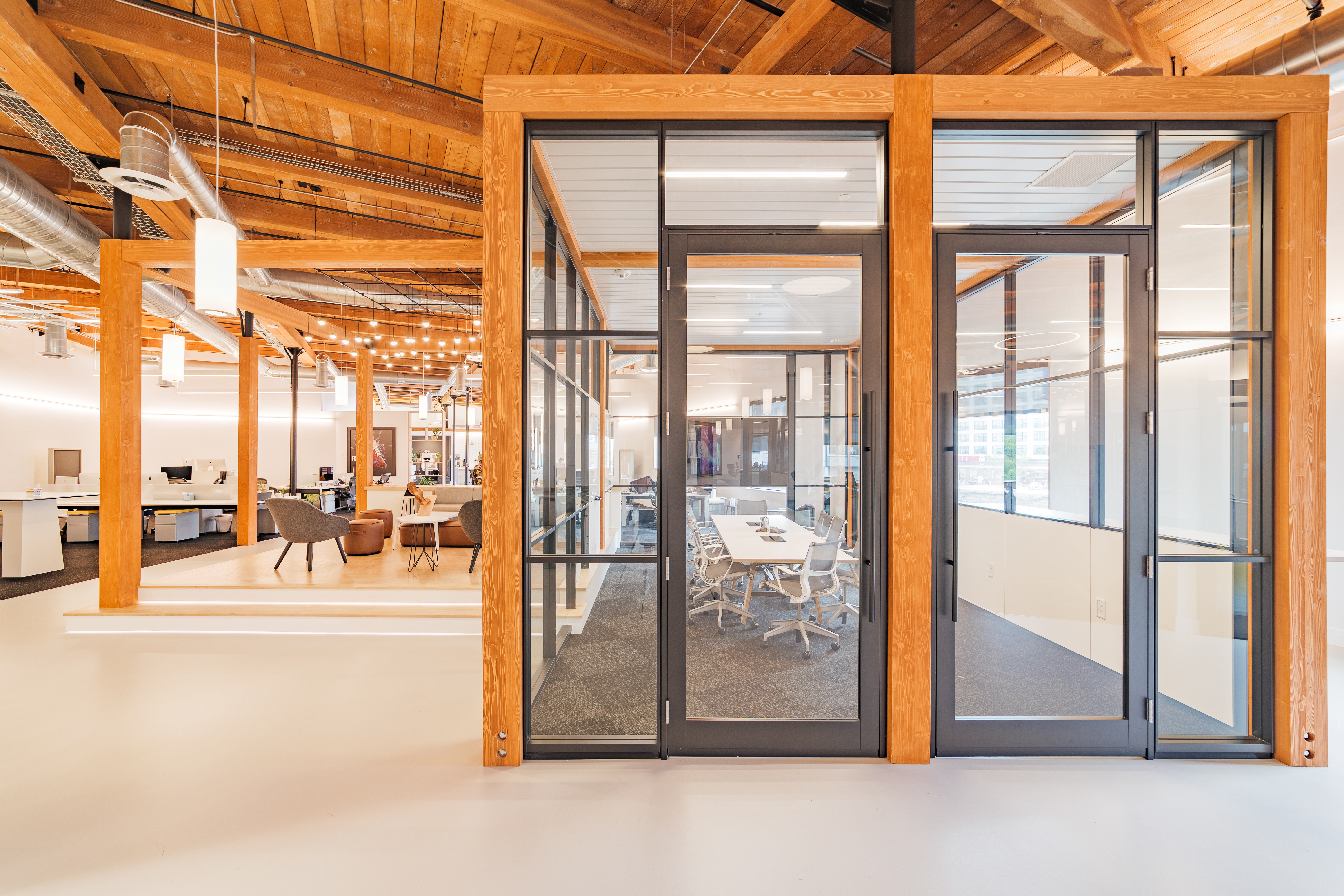Southern yellow pine Timber from DIRTT frames a modular glass wall system and aluminum framed butt hinge doors.