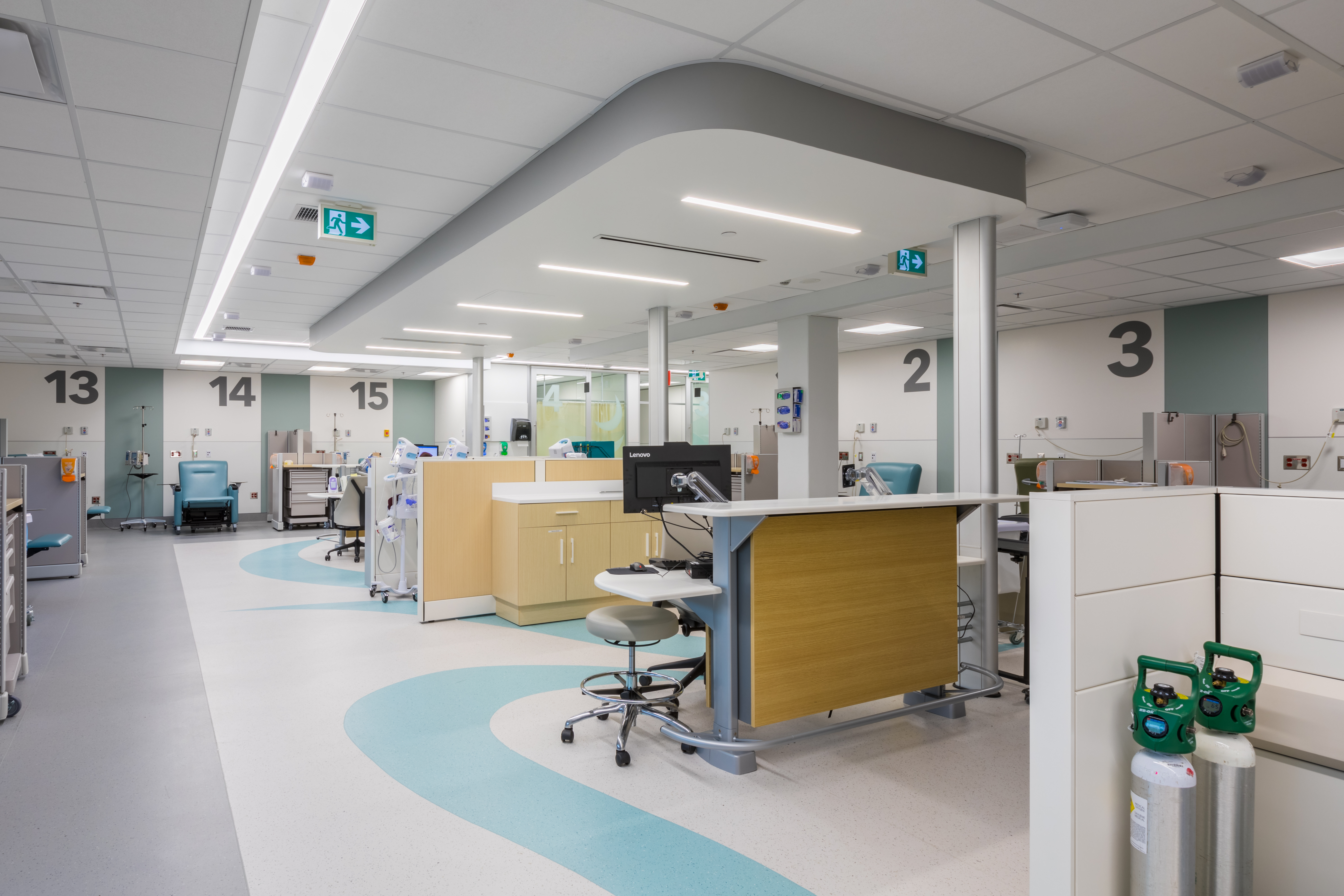 This open hospital area has various exam spaces with DIRTT headwalls and nurse stations.
