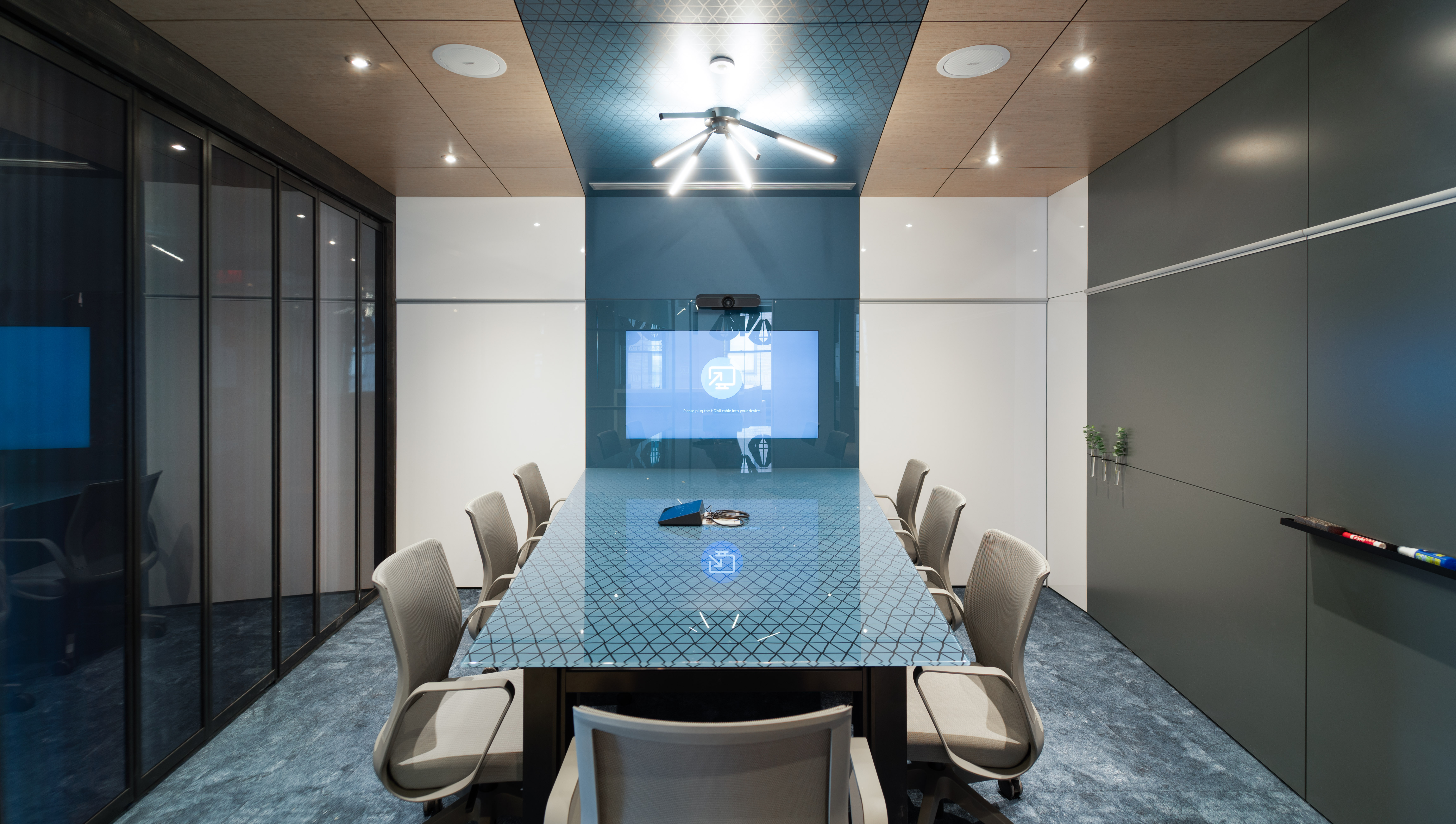 DIRTT's solid and glass modular walls form this meeting room with an integrated display and writeable surfaces.