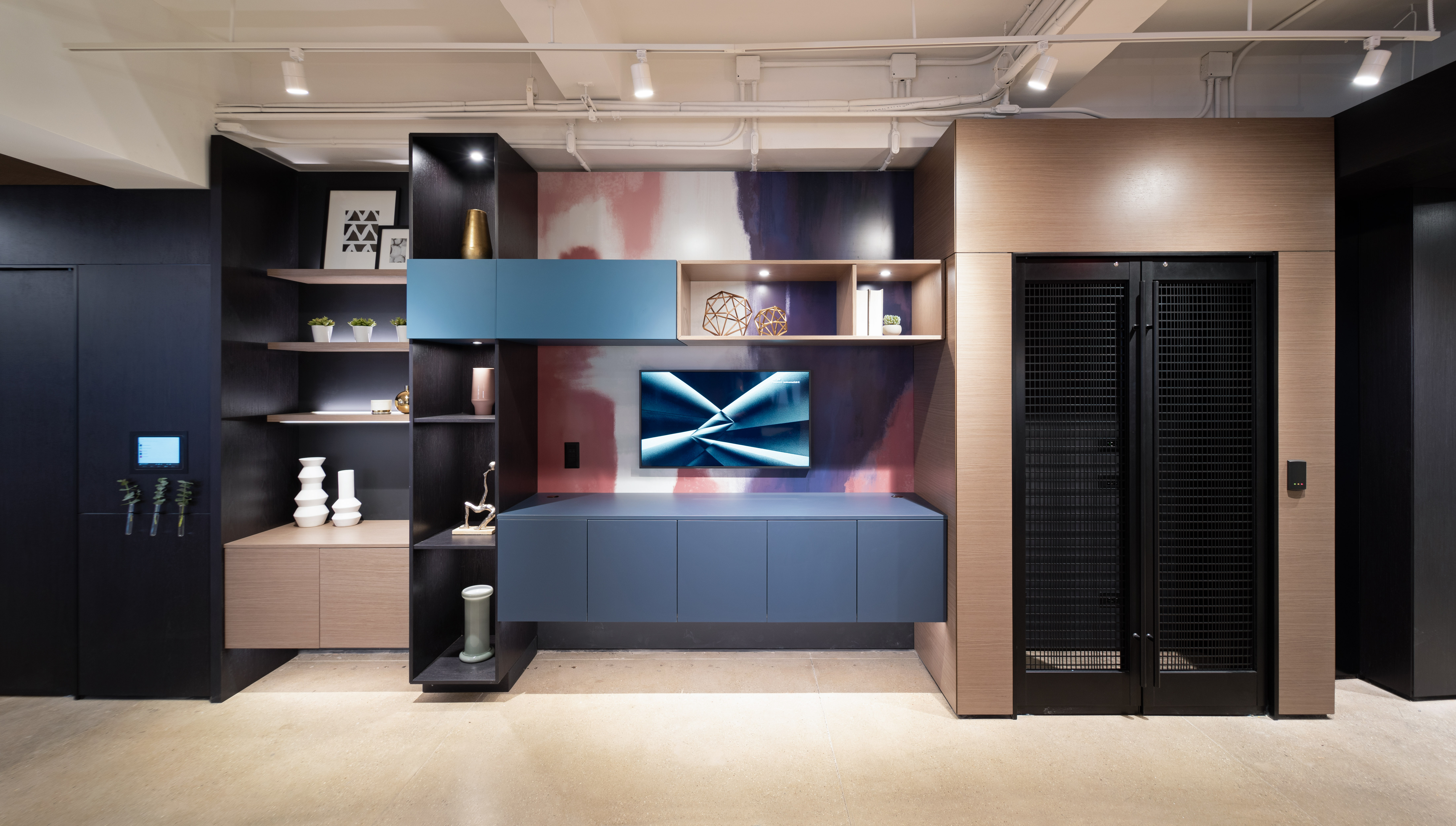 Custom casework cabinets and shelves are along one side of this hallway area in the DIRTT experience center.