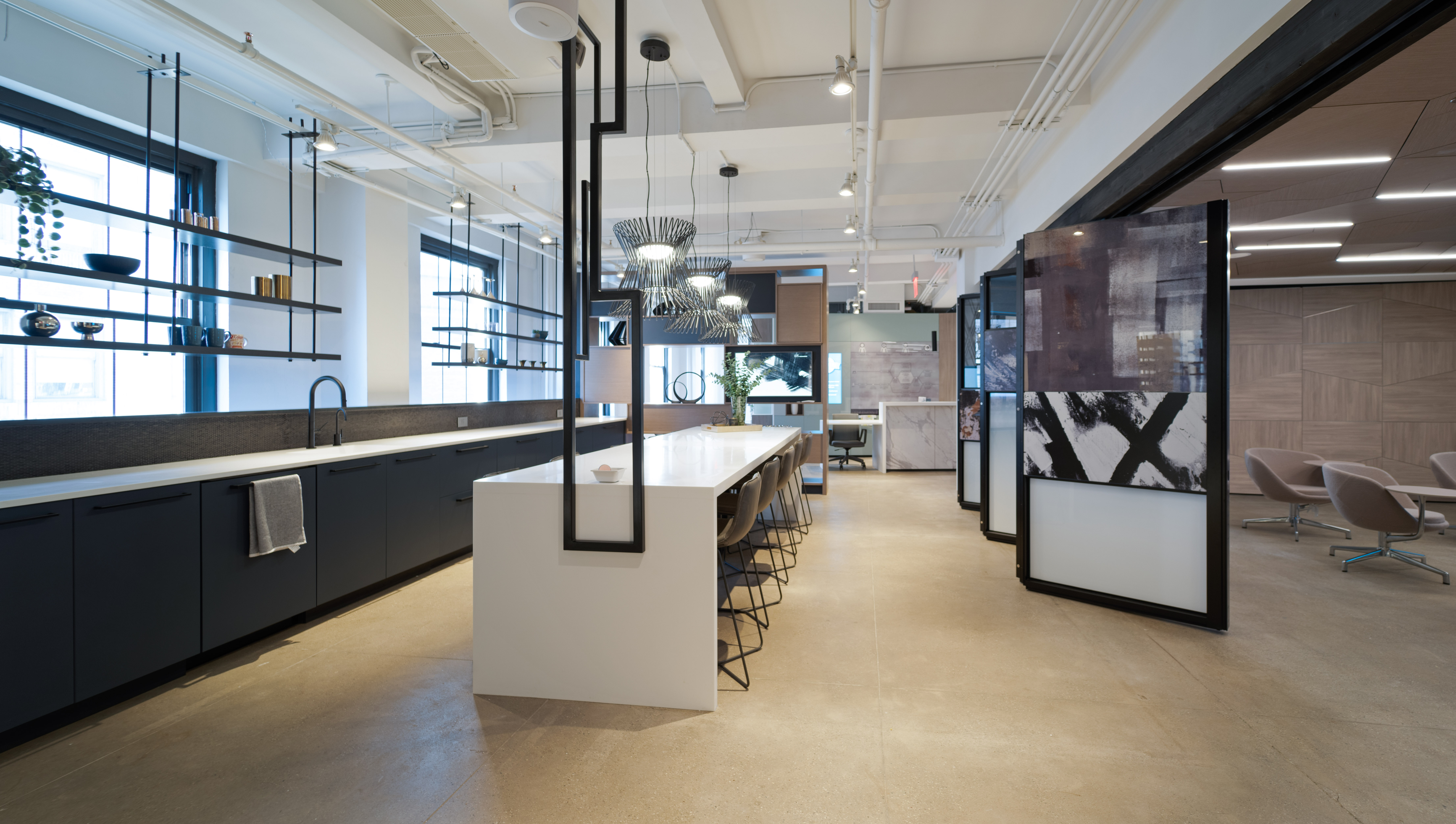 This kitchen breakroom area at DIRTT has a Leaf floating wall that opens up the space to the classroom area.