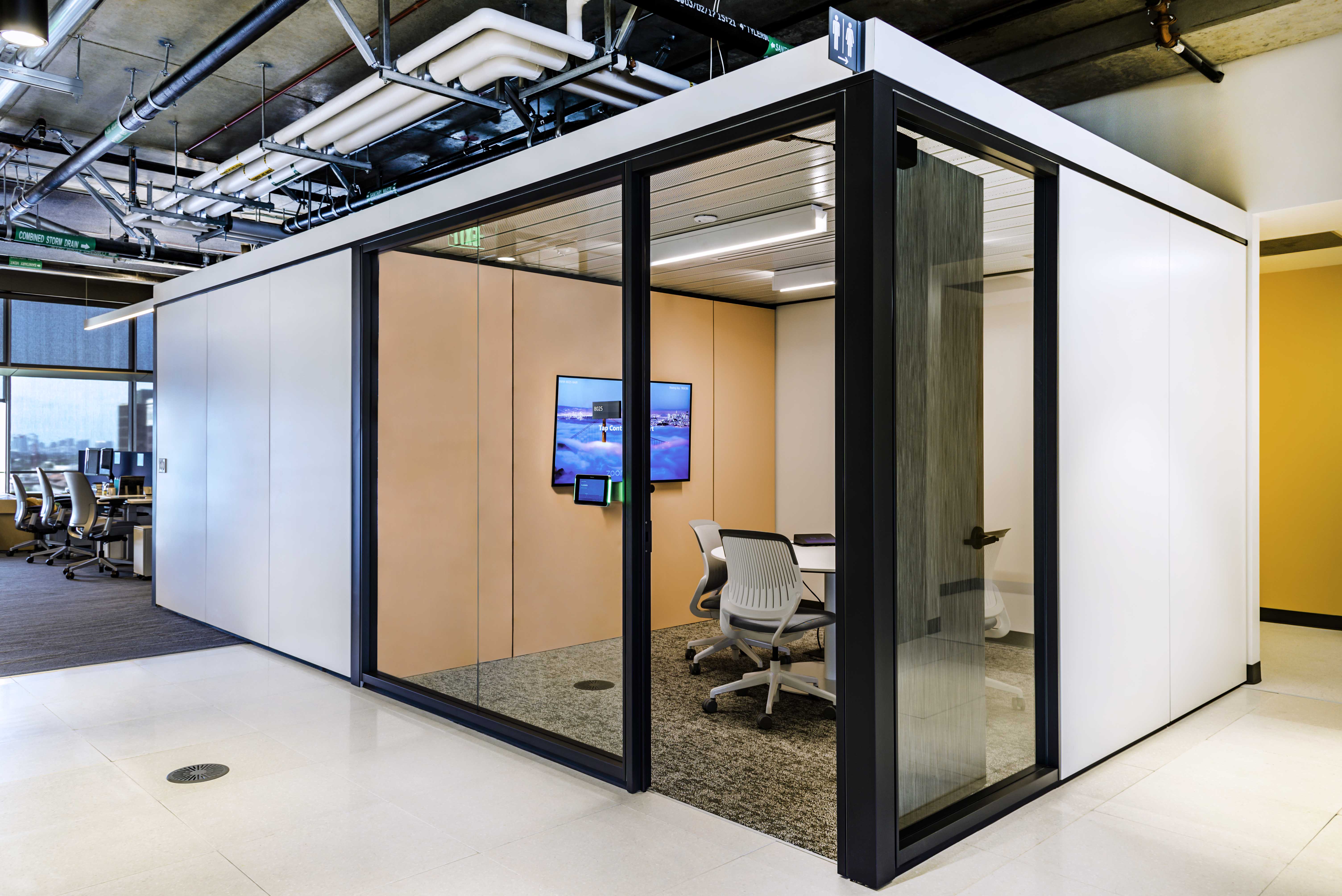 Contemporary university lab space meeting room with mounted glass walls and integrated technology