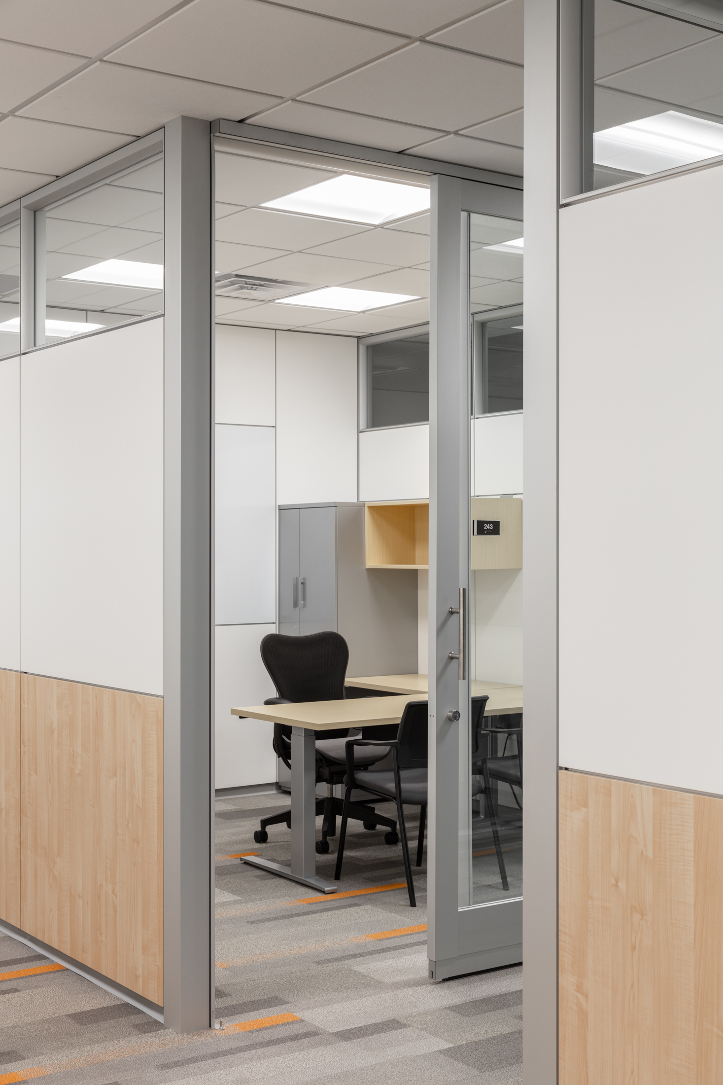 Detail of entry into small modular office space with integrated technology and smooth finishes