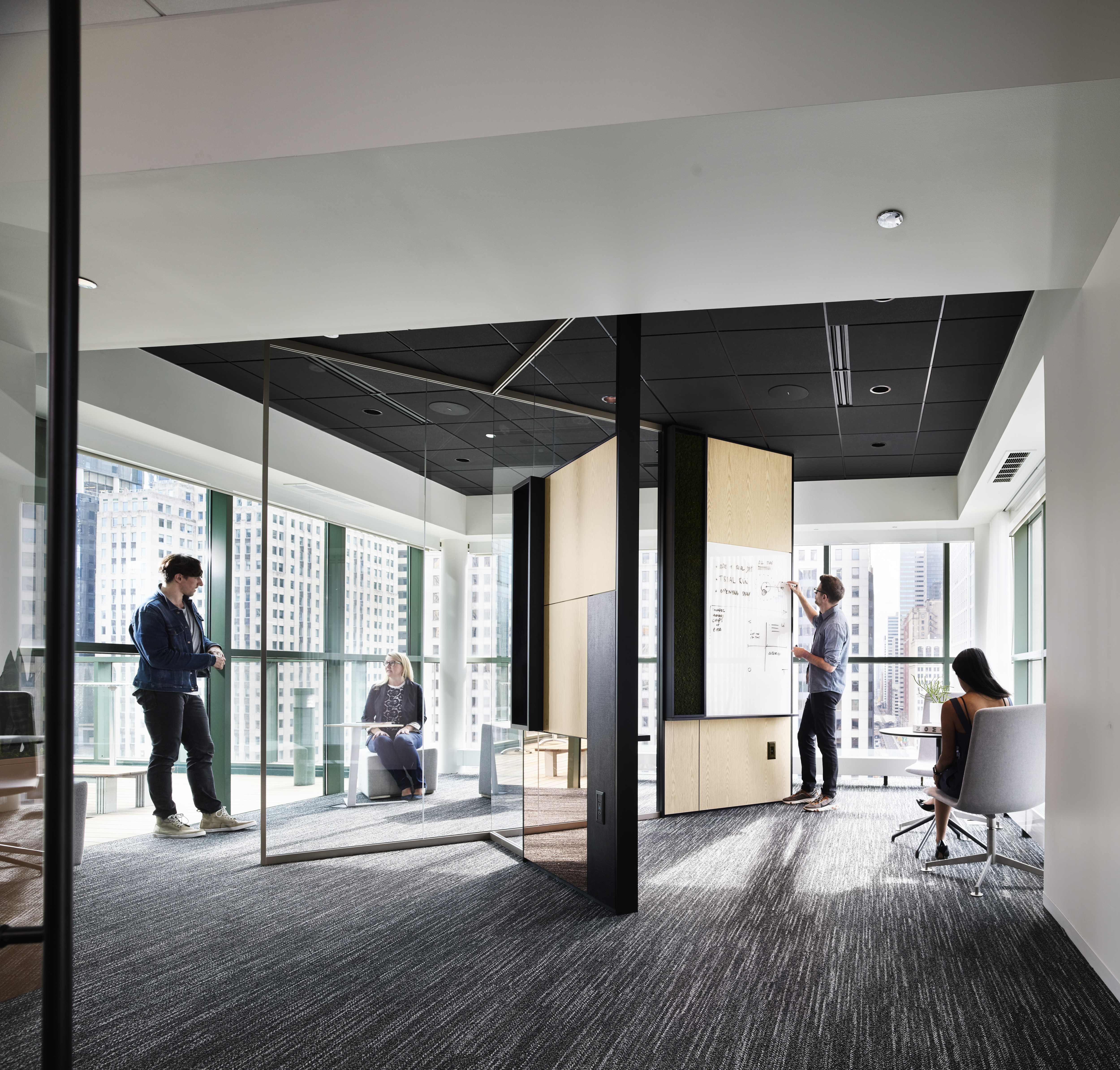 Meeting spaces are divided with DIRTT's combination glass and solid walls featuring writeable surfaces and integrated tech.