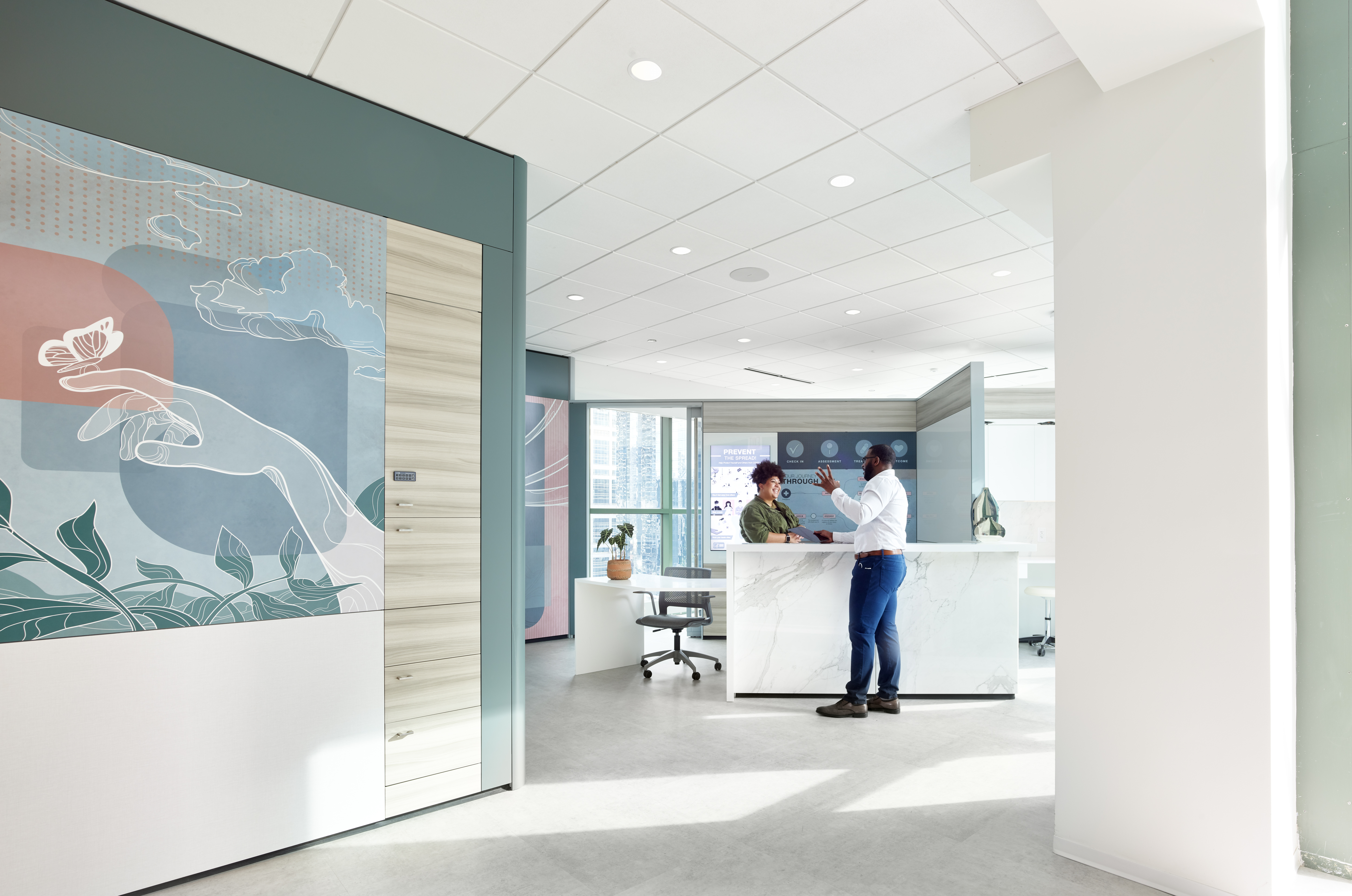 Leading into a nurse station there is a solid DIRTT wall with custom graphics and casework cabinets used for supplies.