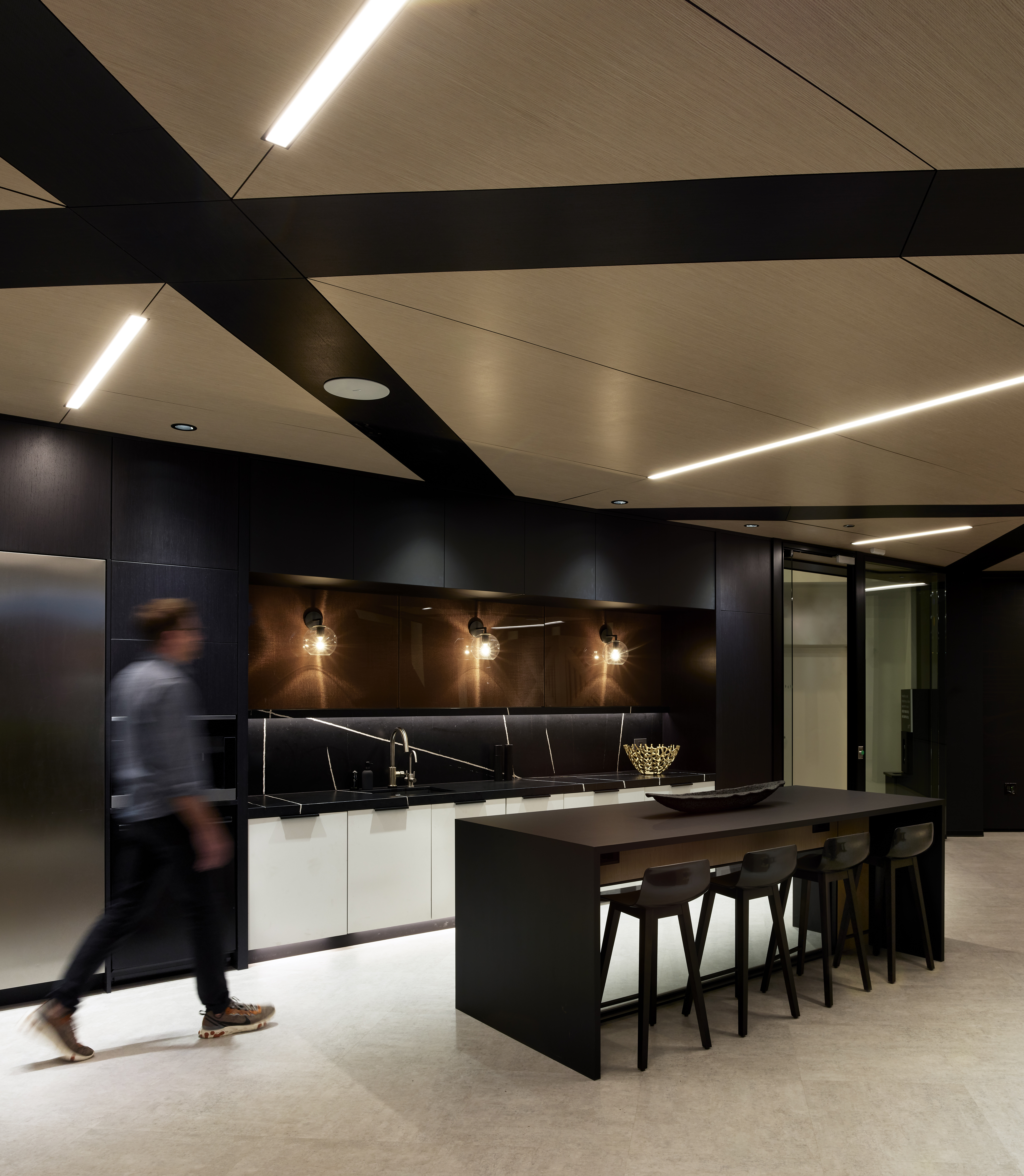This open kitchen area is backed by a solid DIRTT wall featuring custom graphics and custom casework cabinets.