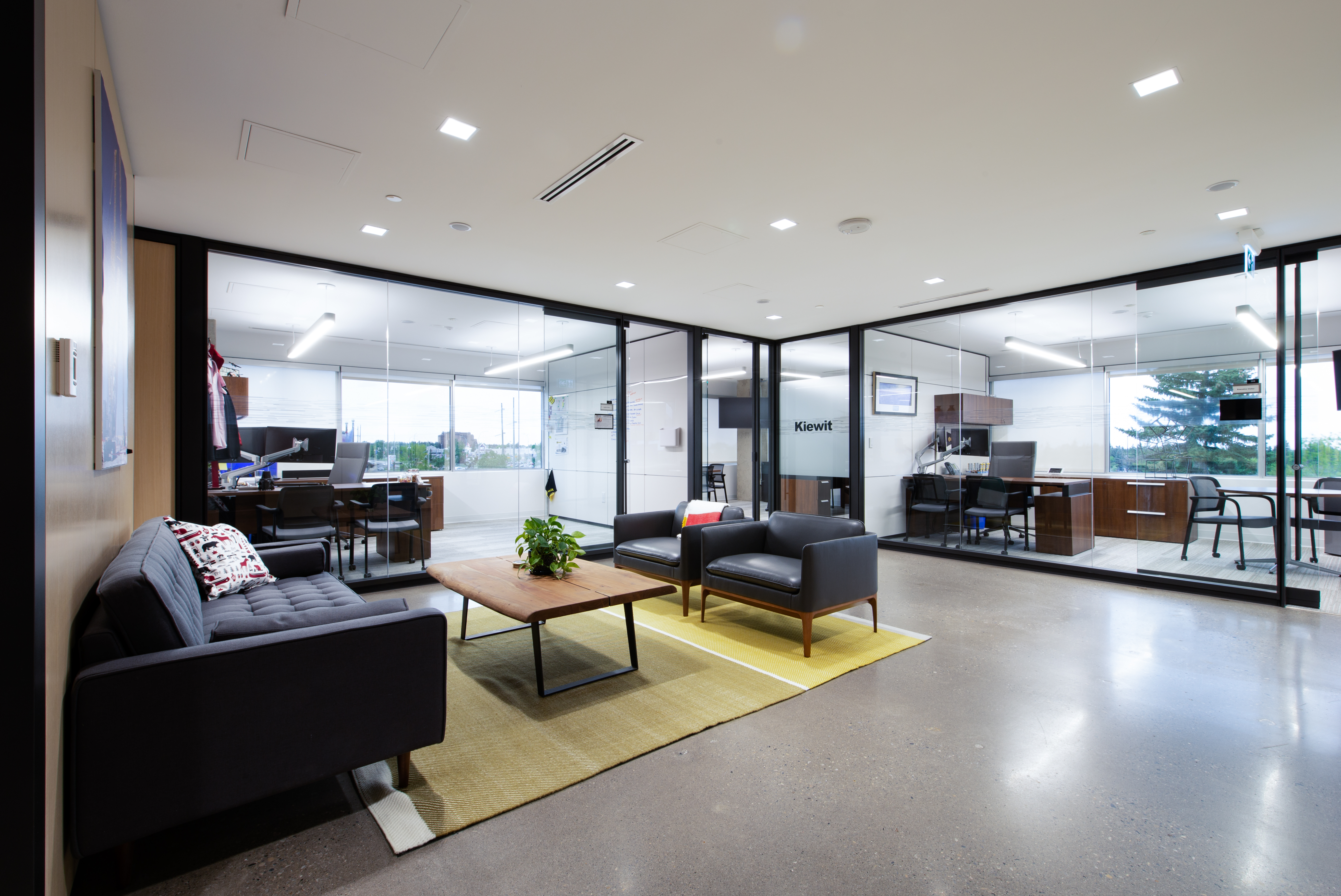 Behind the lobby area DIRTT's modular glass wall system with sliding and pivot doors was used to form private offices.