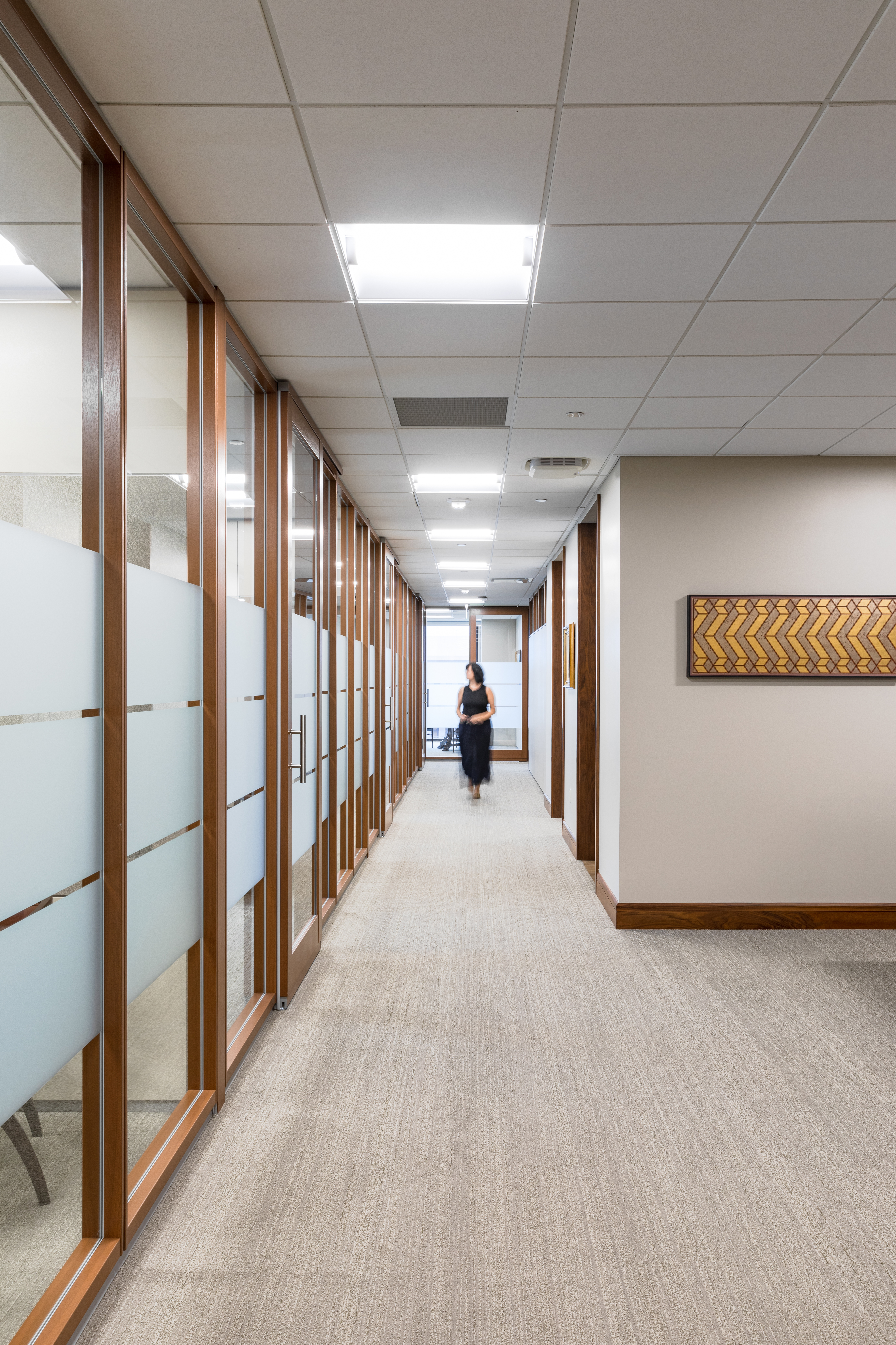On the left side of this hallway are DIRTT's modular glass wall that have been used to create private offices.