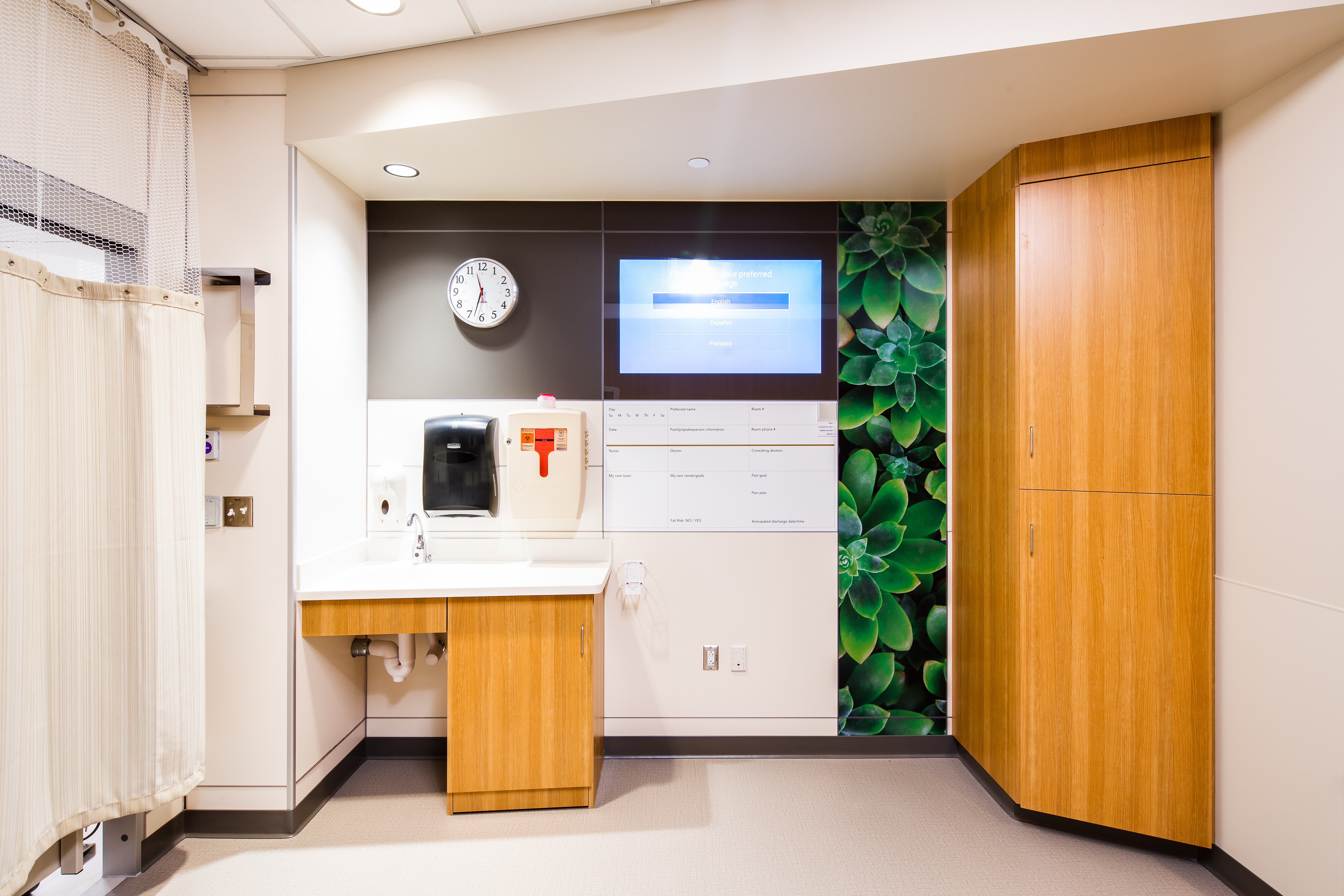 A sink area in a patient room  with a DIRTT solid wall behind it that features integrated technology and writeable surfaces.