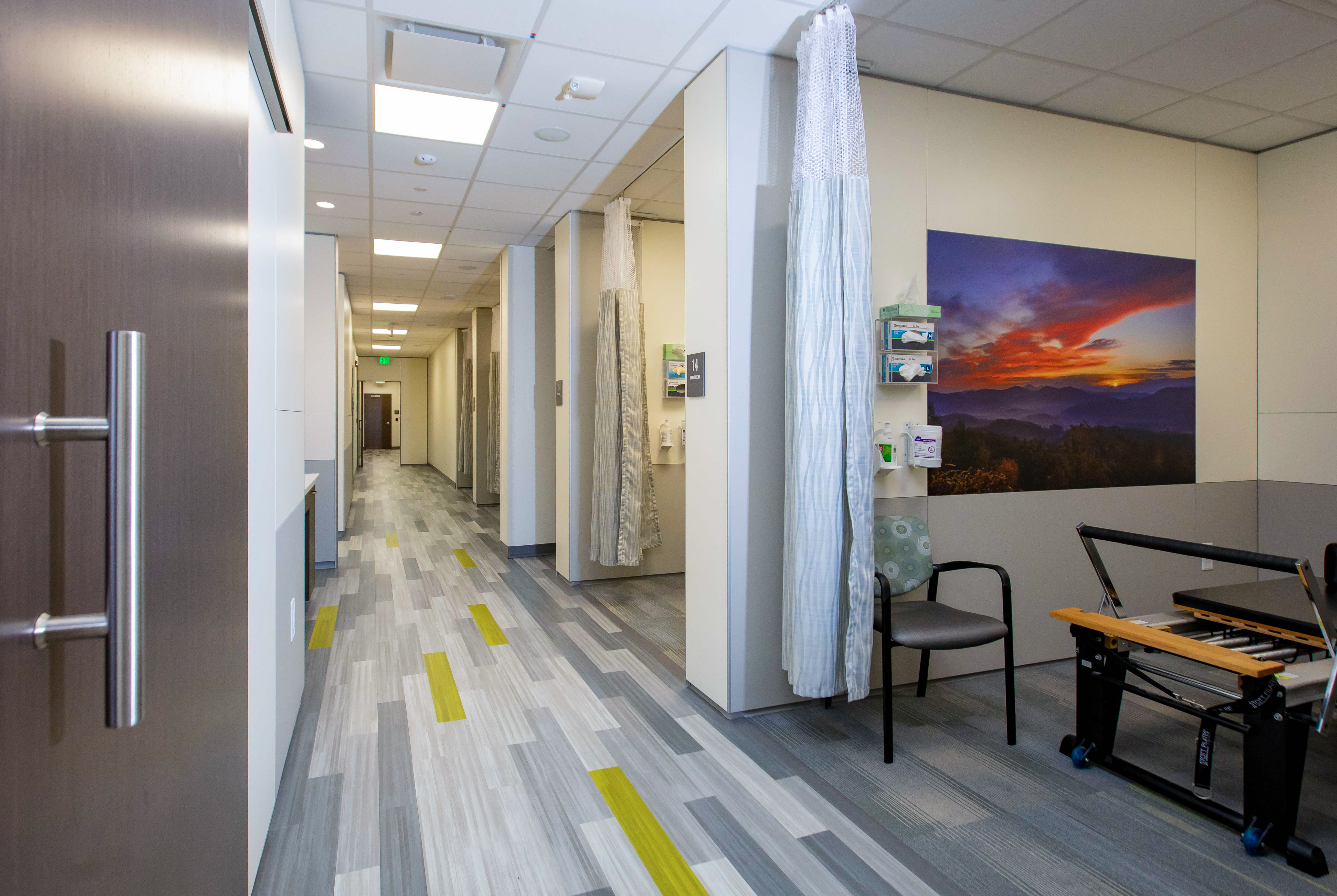 Multiple treatment bays made from DIRTT's solid modular walls line this hallway.