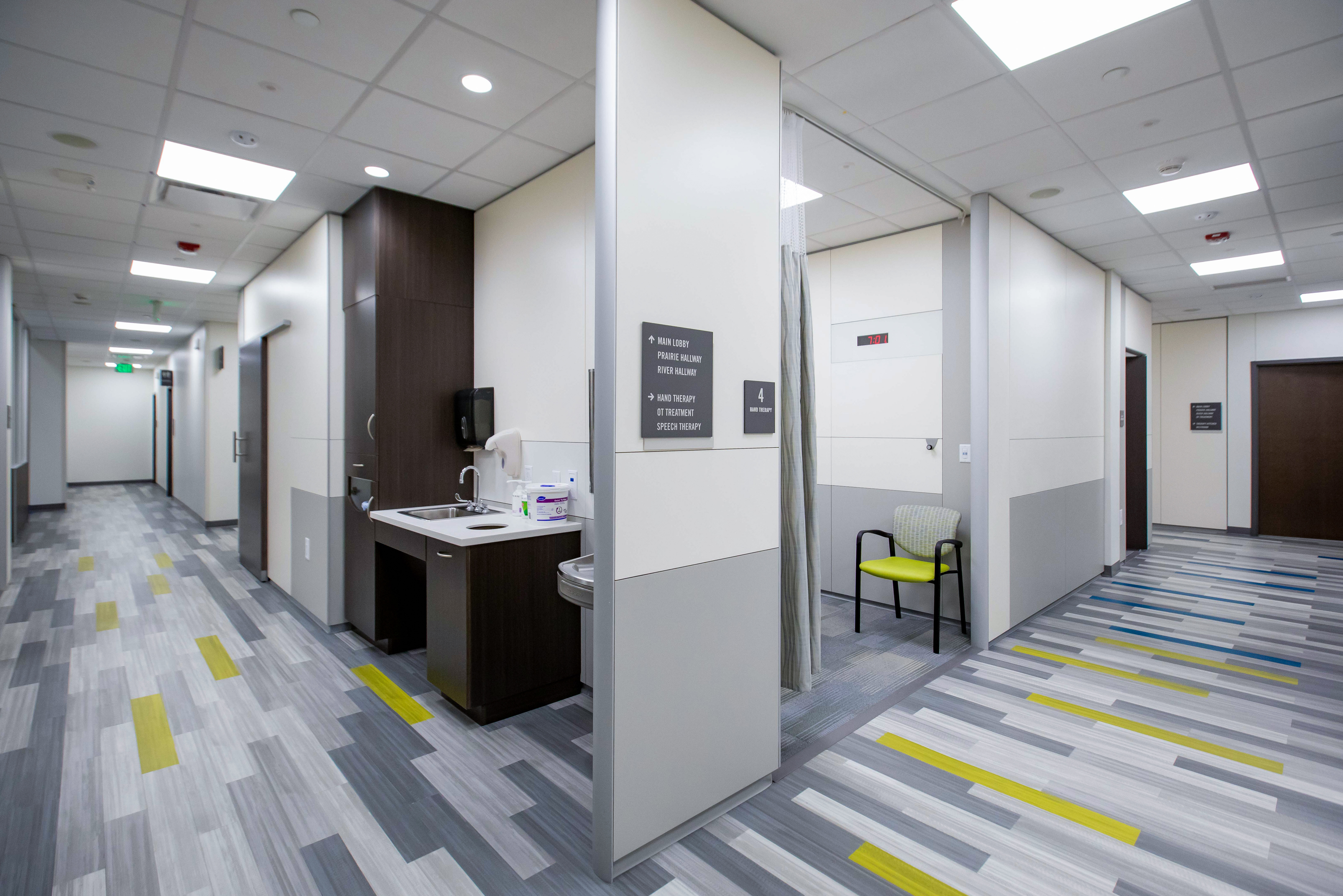 We see a sink area with custom casework cabinets sharing a modular DIRTT wall with a private treatment area.