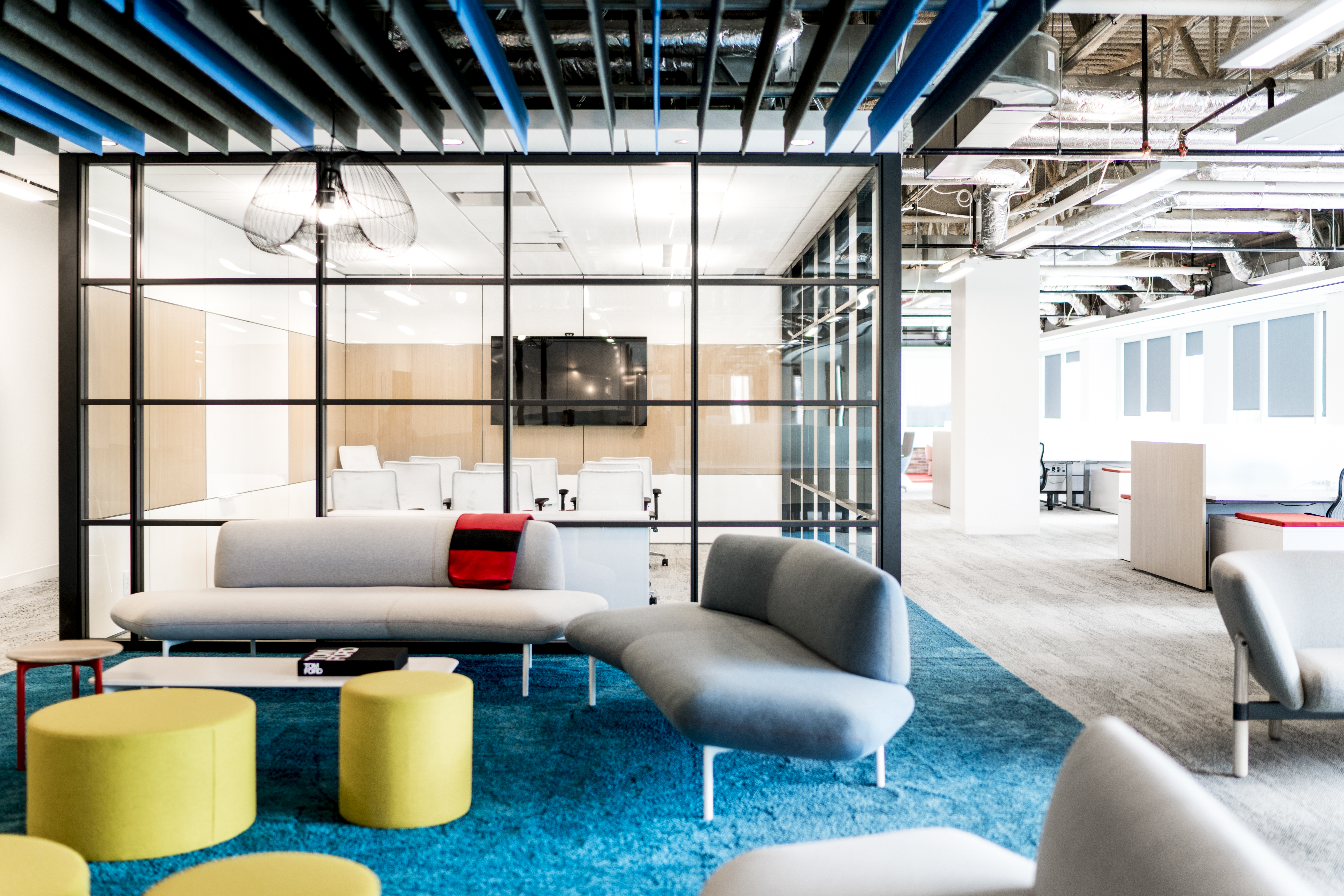 This freestanding meeting room has DIRTT's glass modular walls on two sides and solid modular walls on two sides.