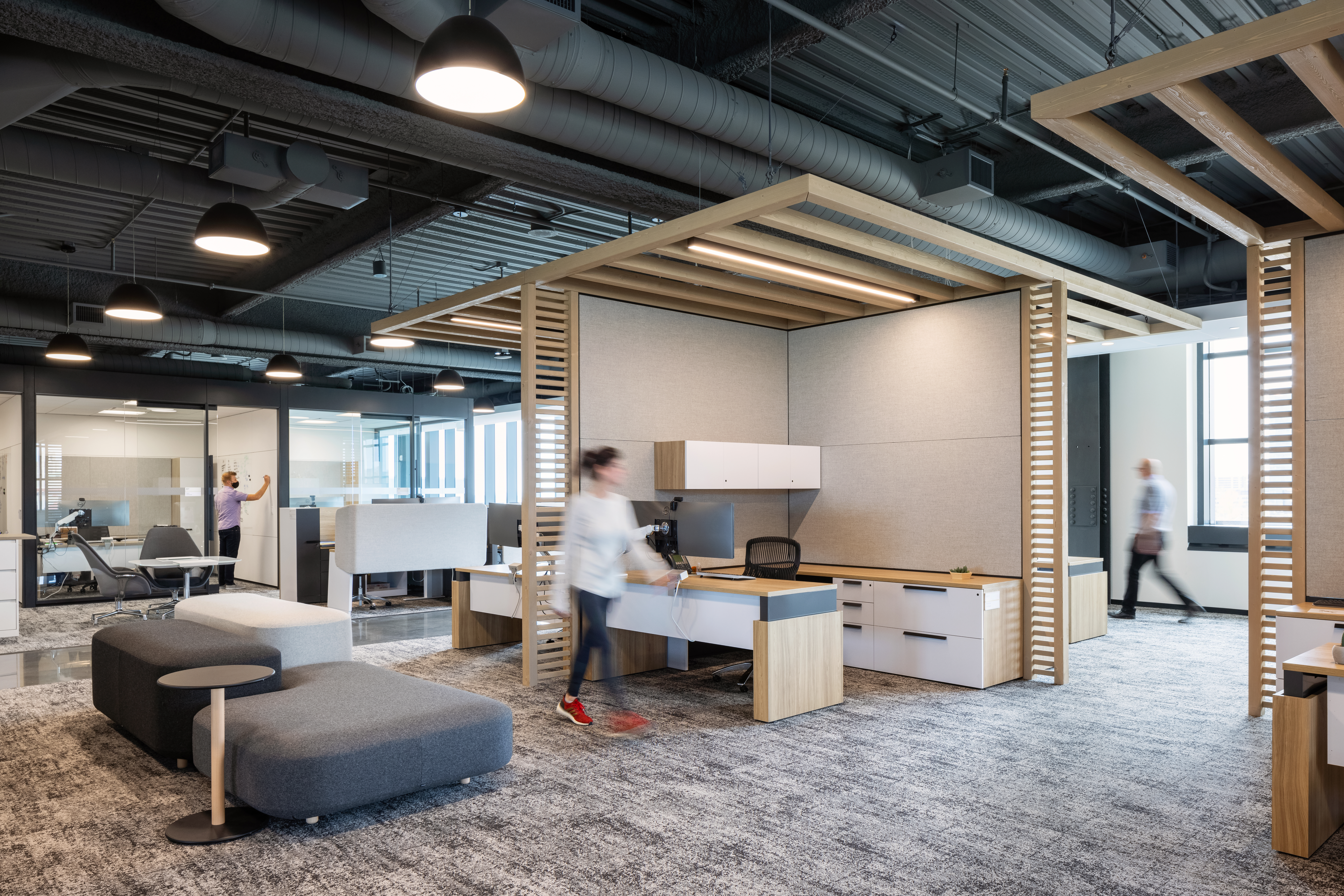 A system of DIRTT products are used in this office space to divide spaces including Timber Frame, custom casework, and solid and glass modular walls.